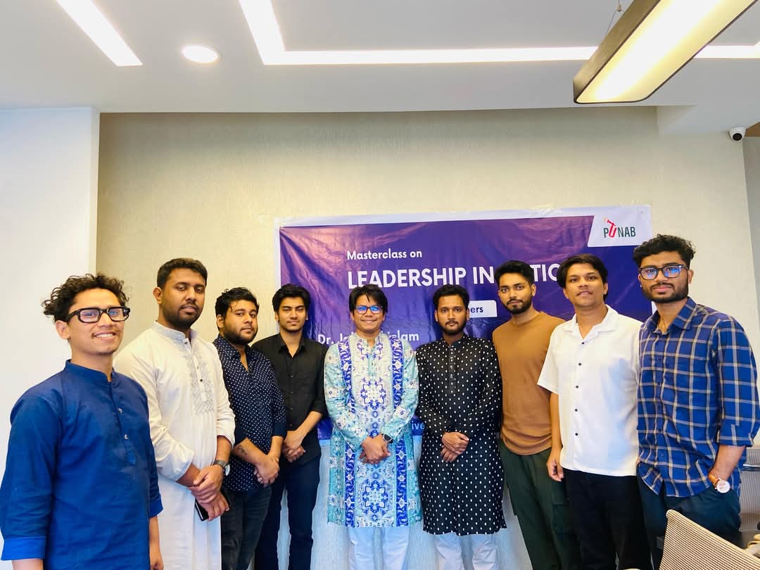 Group of people standing in front of a banner